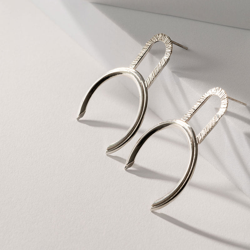 Big geometric silver earrings by Montreal jewelry designer Veronique Roy